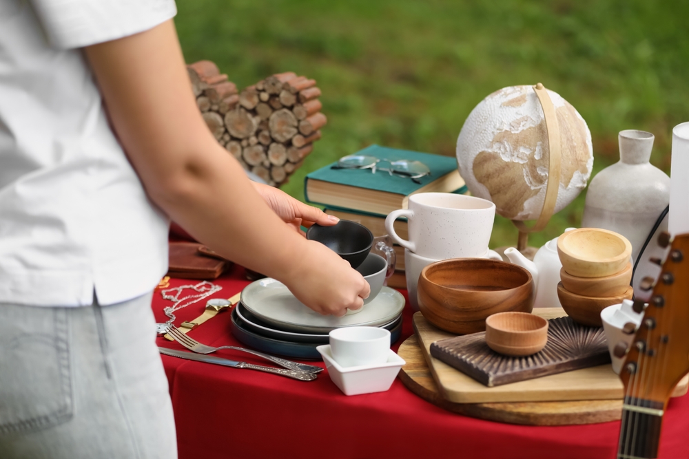 Woman,Holding,Beautiful,Bowls,Near,Table,With,Different,Items,On estate-cleanout-yard-sale